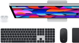 Top down view of Studio Display monitor, black Magic Keyboard, black Magic Mouse, black Magic Trackpad and white AirPods case