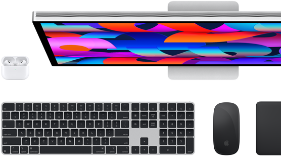 Top down view of Studio Display monitor,black Magic Keyboard,black Magic Mouse,black Magic Trackpad and #fff AirPods case