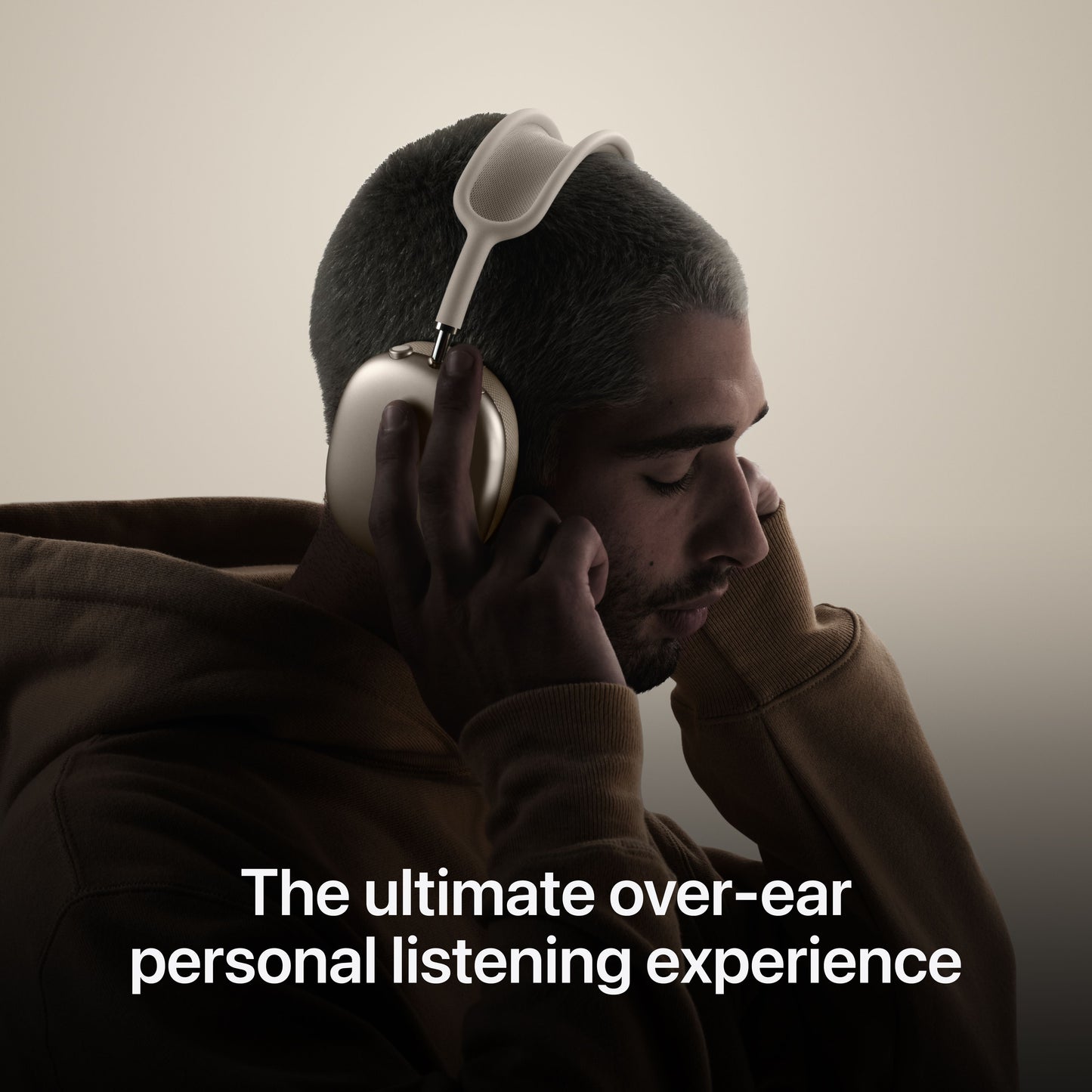 Person wearing AirPods Max in Starlight highlighting over-ear listening experience